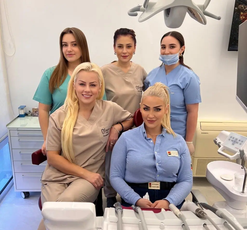 The doctors and assistants beside a dental chair